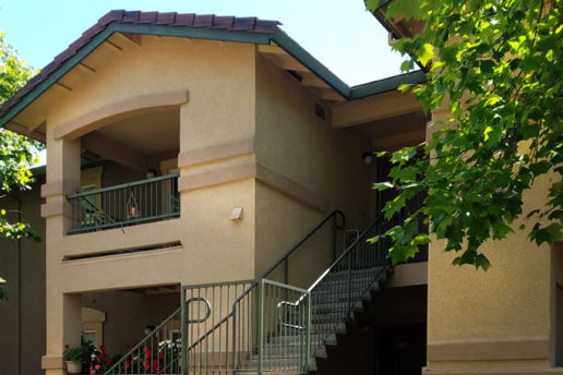 Exterior of Sierra Creek with stairs leading up to apartments 
