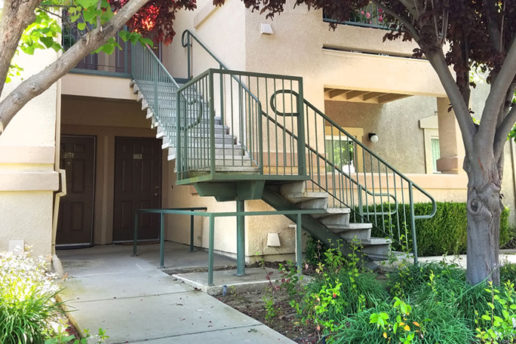 Exterior of Sierra Creek with stairs leading up to apartments